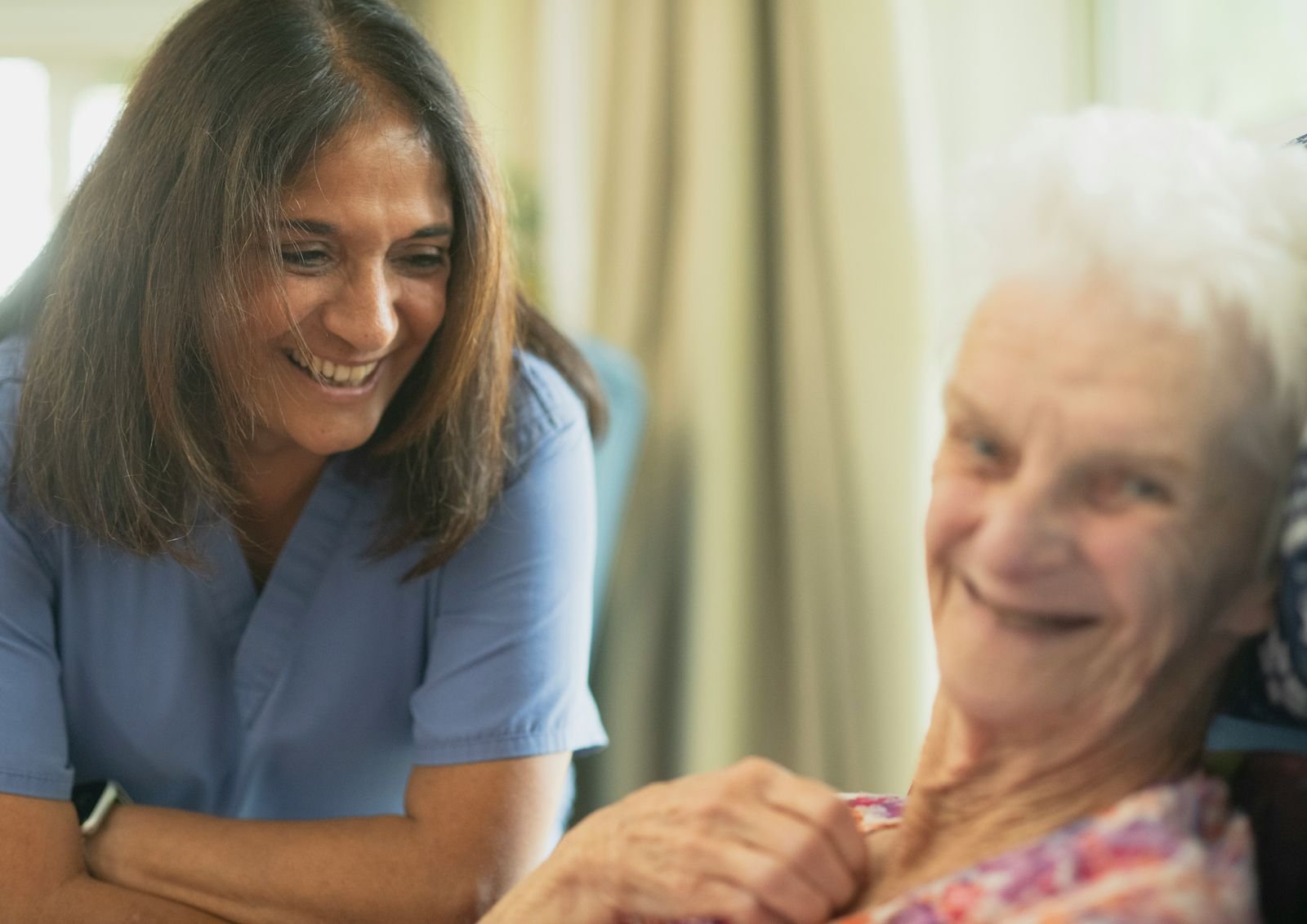 Caregiver assisting a senior woman with daily personal care