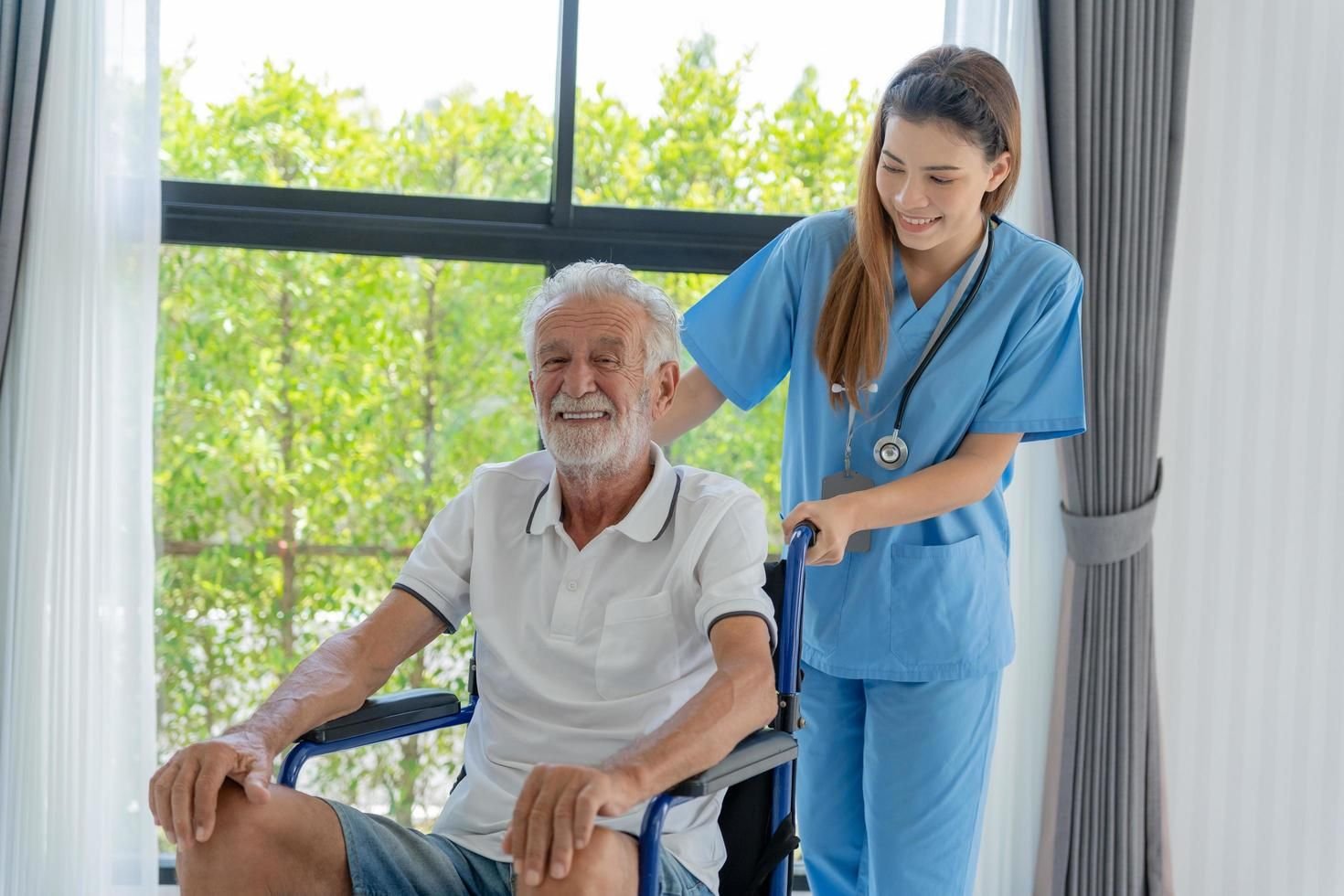 A caregiver supporting a smiling senior man at home in Calgary